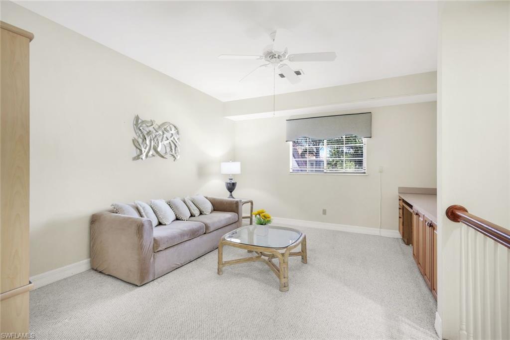 2451 Game Hawk Court, Unit 2502 Naples, FL 34105 - Photo 5 of 30 a living room with furniture and a window