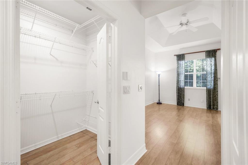2451 Game Hawk Court, Unit 2502 Naples, FL 34105 - Photo 8 of 30 a view of a room with wooden floor and cabinet