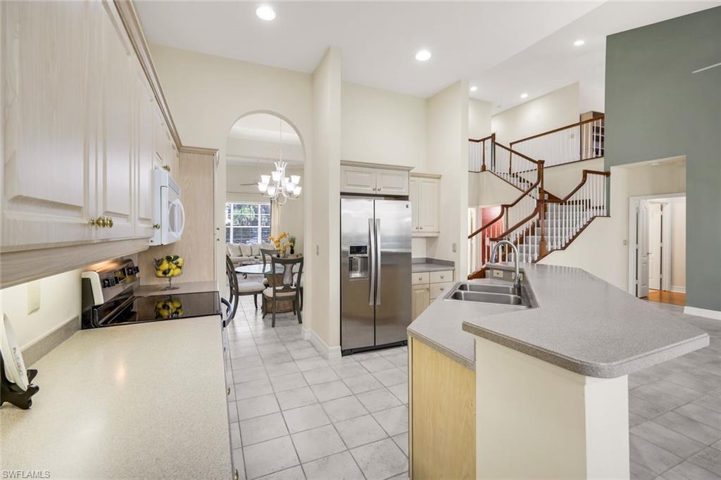 2451 Game Hawk Court, Unit 2502 Naples, FL 34105 - Photo 30 of 30 a view of a kitchen with furniture and a refrigerator