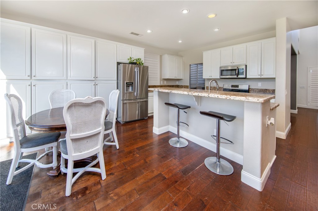 25313 Rolling Greens Way Saugus, CA 91350 - Photo 12 of 28 a living room filled with furniture and kitchen view