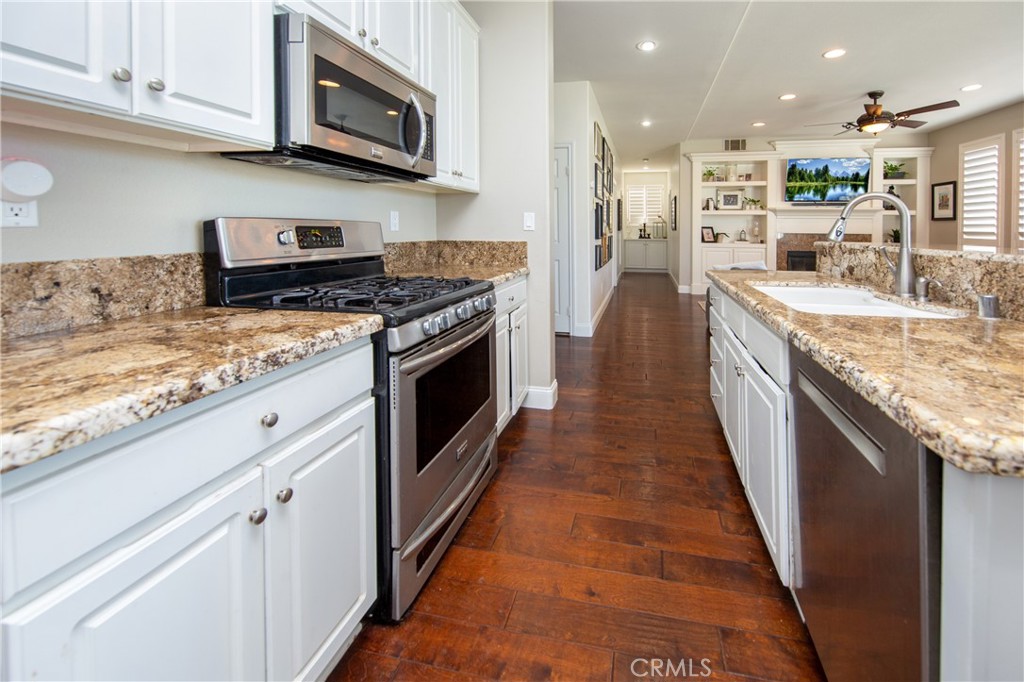 25313 Rolling Greens Way Saugus, CA 91350 - Photo 13 of 28 a kitchen with stainless steel appliances granite countertop a stove top oven a sink and a microwave