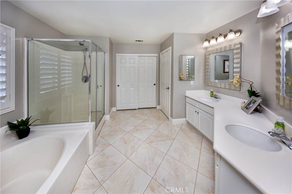 25313 Rolling Greens Way Saugus, CA 91350 - Photo 19 of 28 a spacious bathroom with a tub sink double vanity and a mirror
