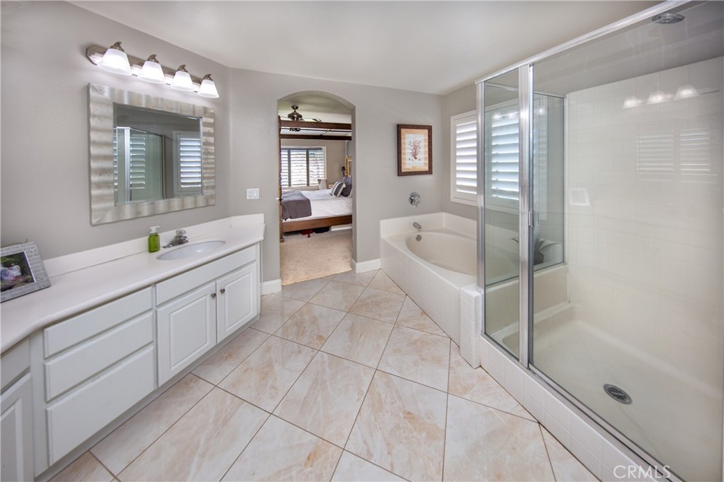 25313 Rolling Greens Way Saugus, CA 91350 - Photo 20 of 28 a spacious bathroom with a double vanity sink a mirror and a bathtub