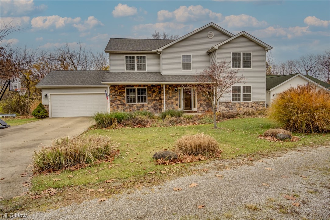 Front facade featuring a garage and a front lawn
