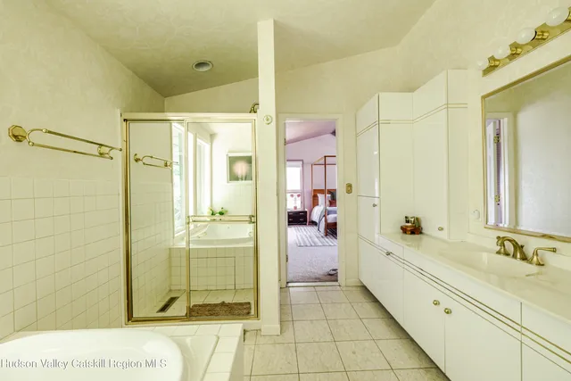 a bathroom with a sink a mirror and a shower