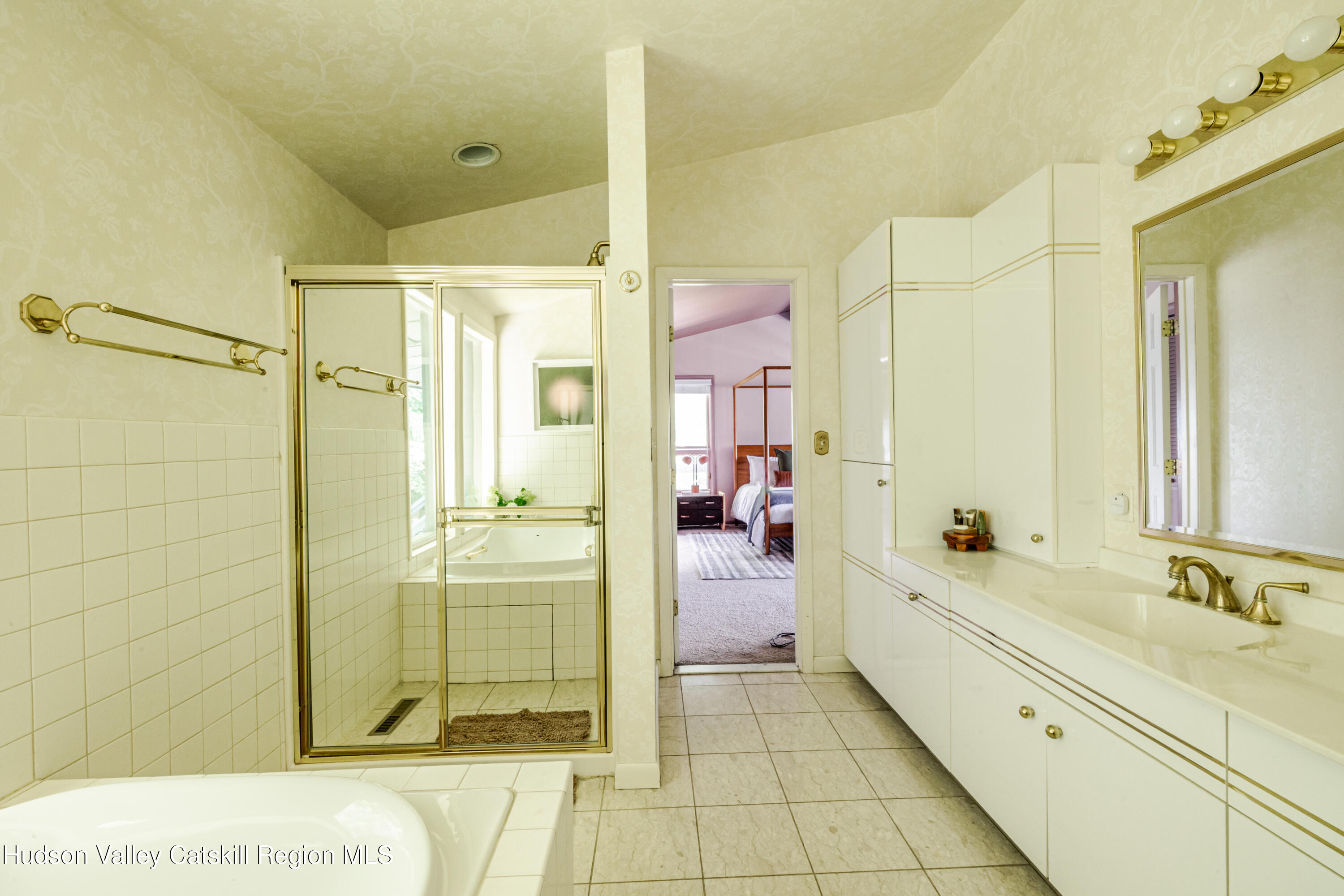 407 Mill Street Windham, NY 12496 - Photo 17 of 39 a bathroom with a sink a mirror and a shower