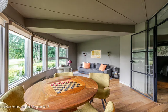a dining room with furniture and wooden floor