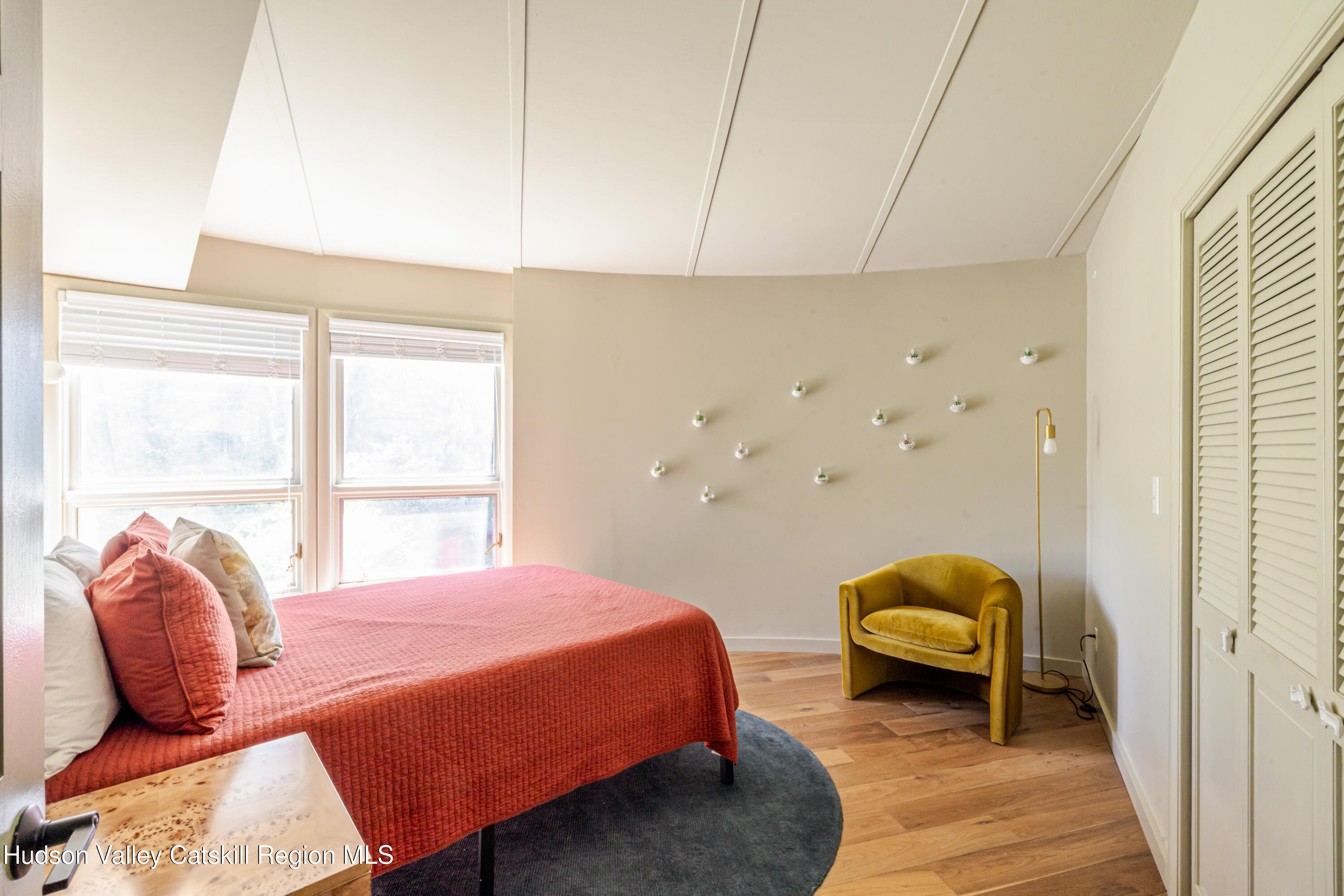 407 Mill Street Windham, NY 12496 - Photo 30 of 39 a bedroom with a bed and wooden floor