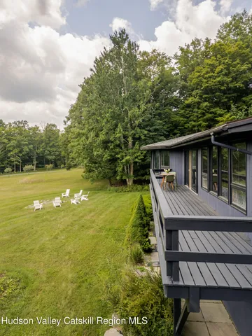 a view of a house with pool and a chairs