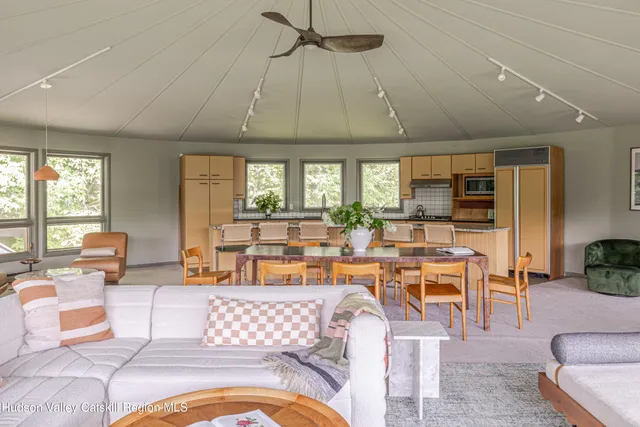 a living room with lots of furniture and a large window
