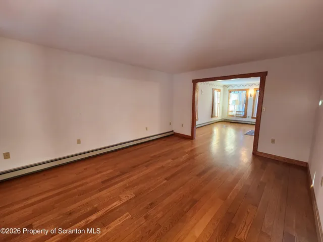 wooden floor in an empty room with a window
