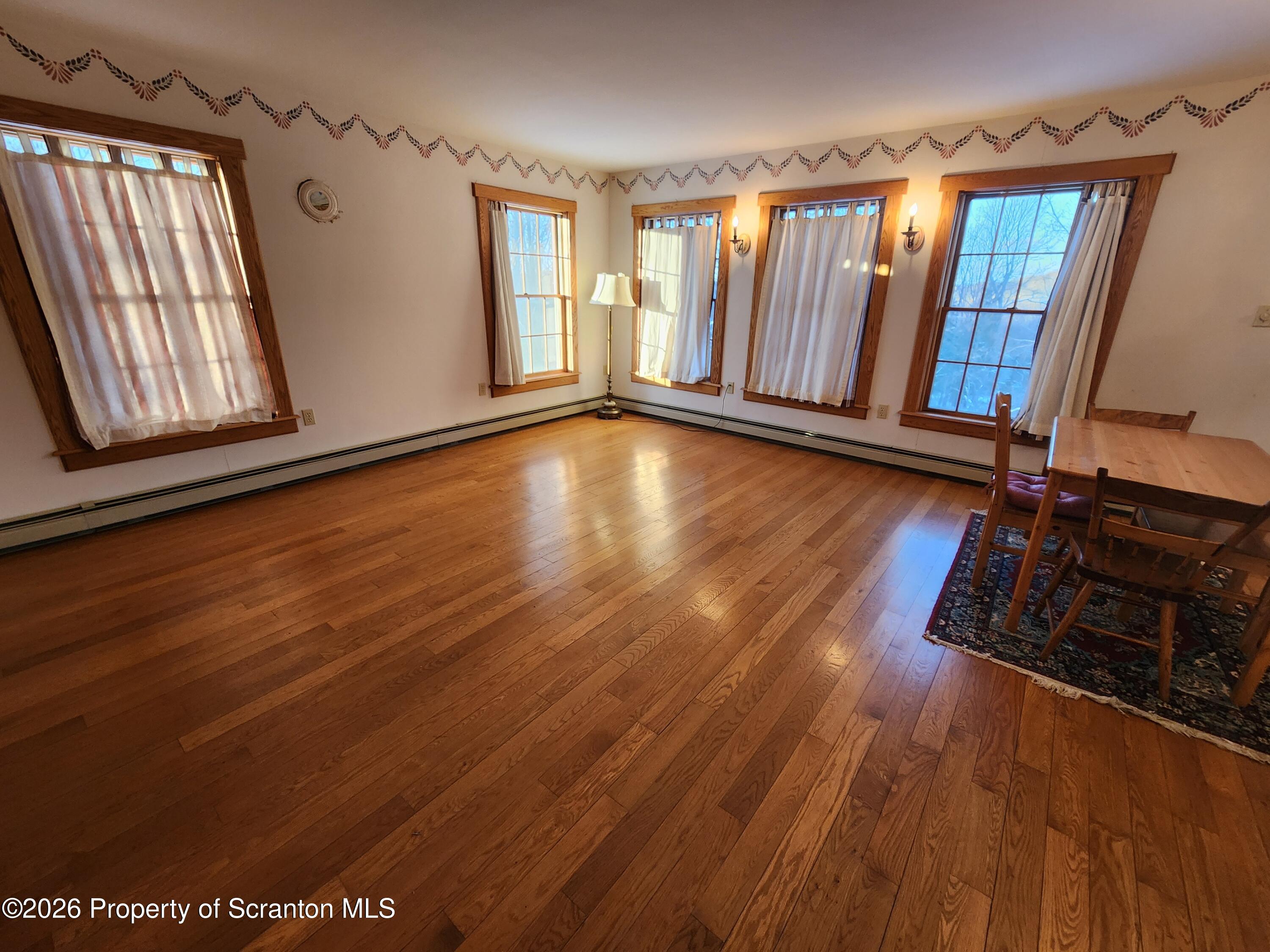 648 Dundaff Street Carbondale, PA 18407 - Photo 15 of 35 wooden floor in an empty room with a window