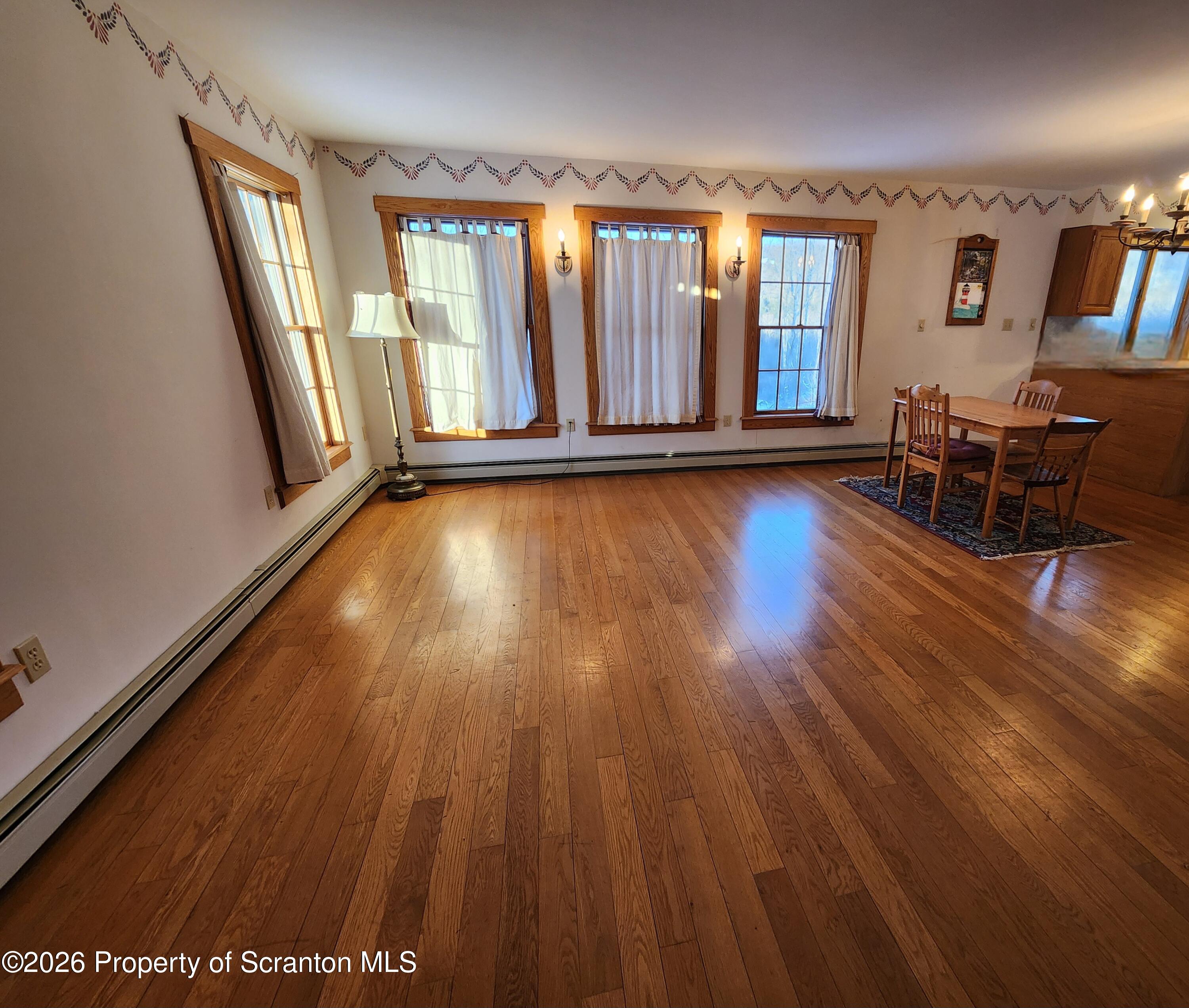 648 Dundaff Street Carbondale, PA 18407 - Photo 17 of 35 wooden floor in an empty room with a window