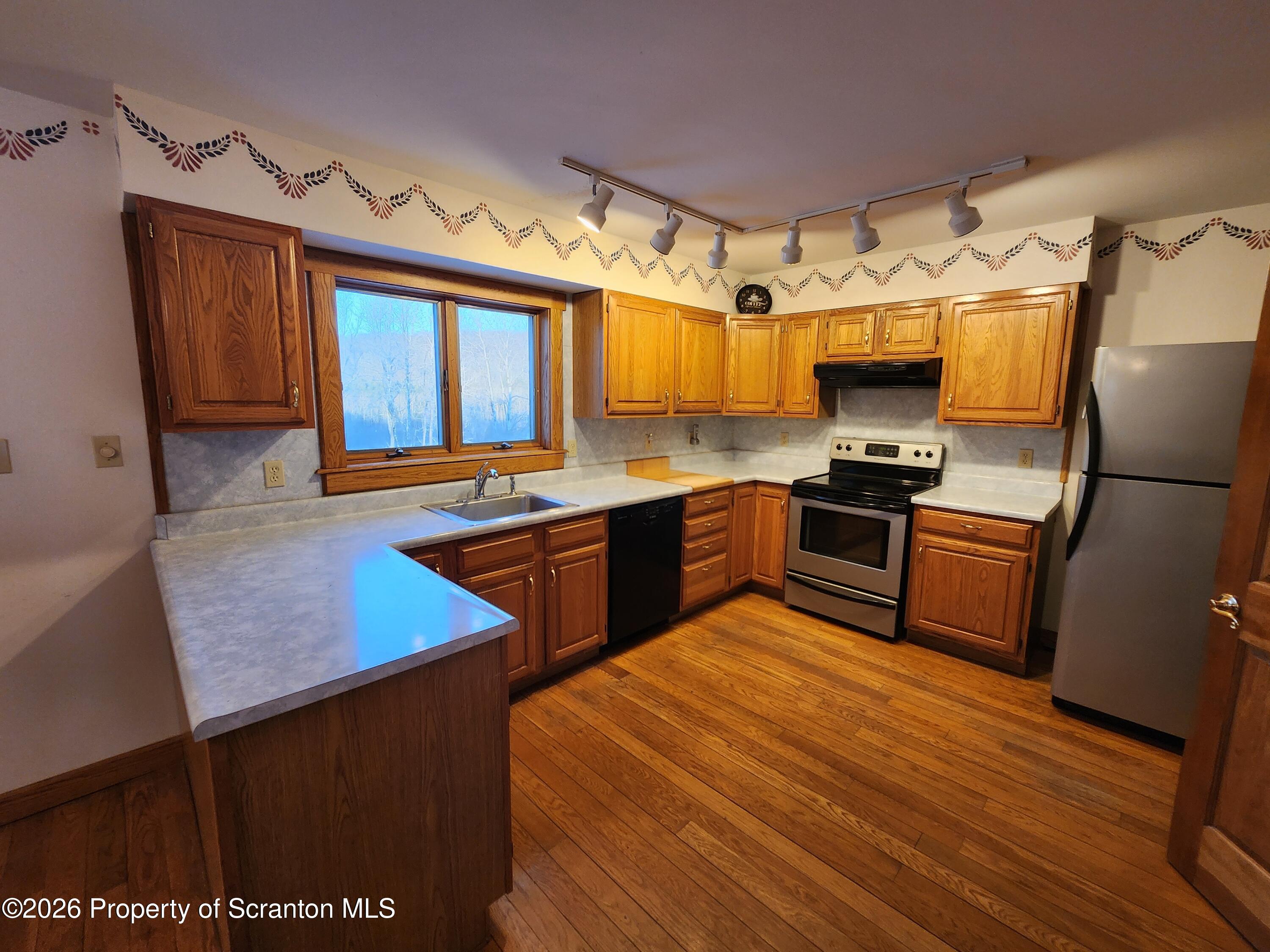 648 Dundaff Street Carbondale, PA 18407 - Photo 18 of 35 a kitchen with stainless steel appliances granite countertop a sink stove and refrigerator