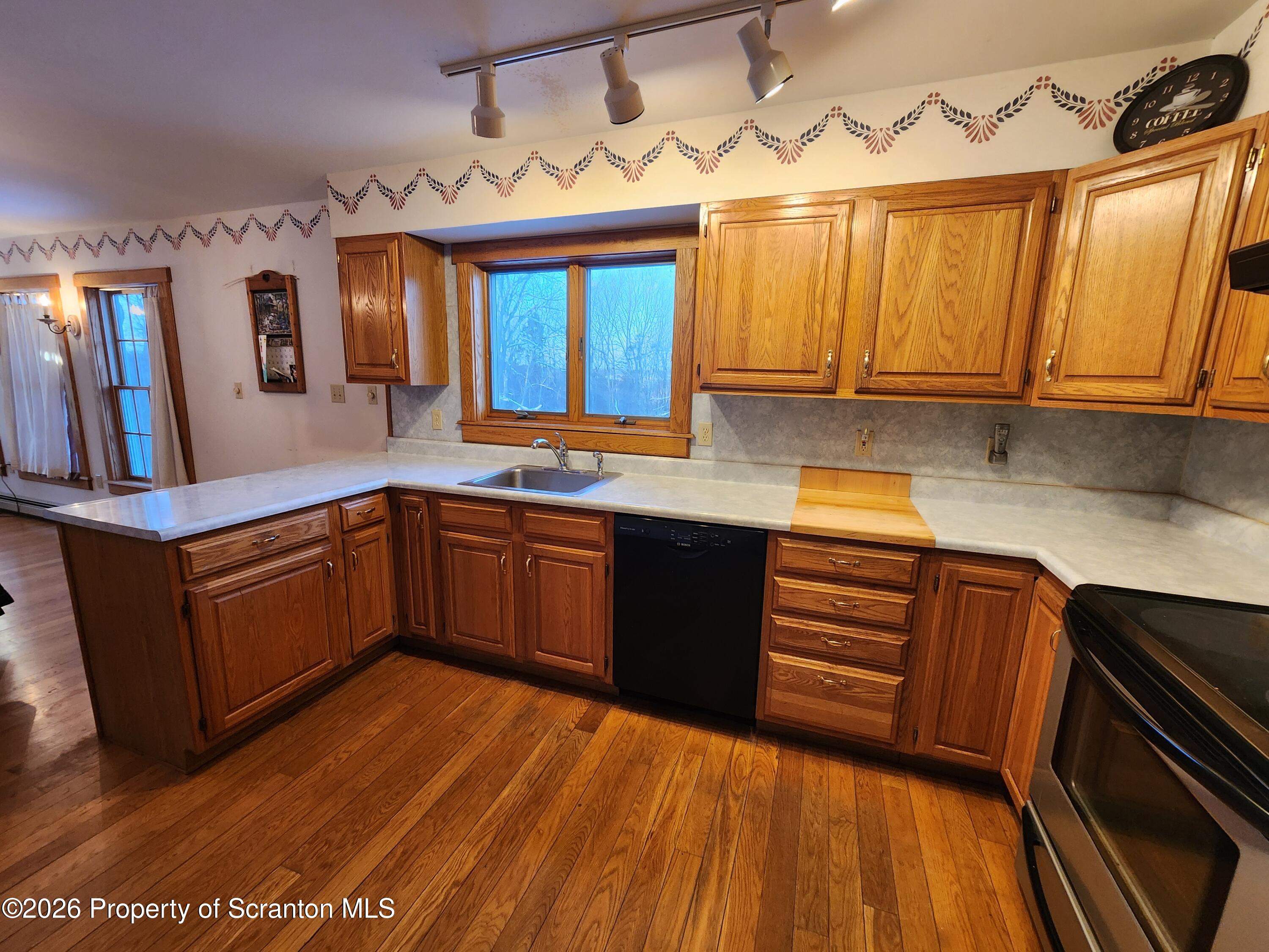648 Dundaff Street Carbondale, PA 18407 - Photo 19 of 35 a kitchen with stainless steel appliances granite countertop wooden cabinets a sink and dishwasher