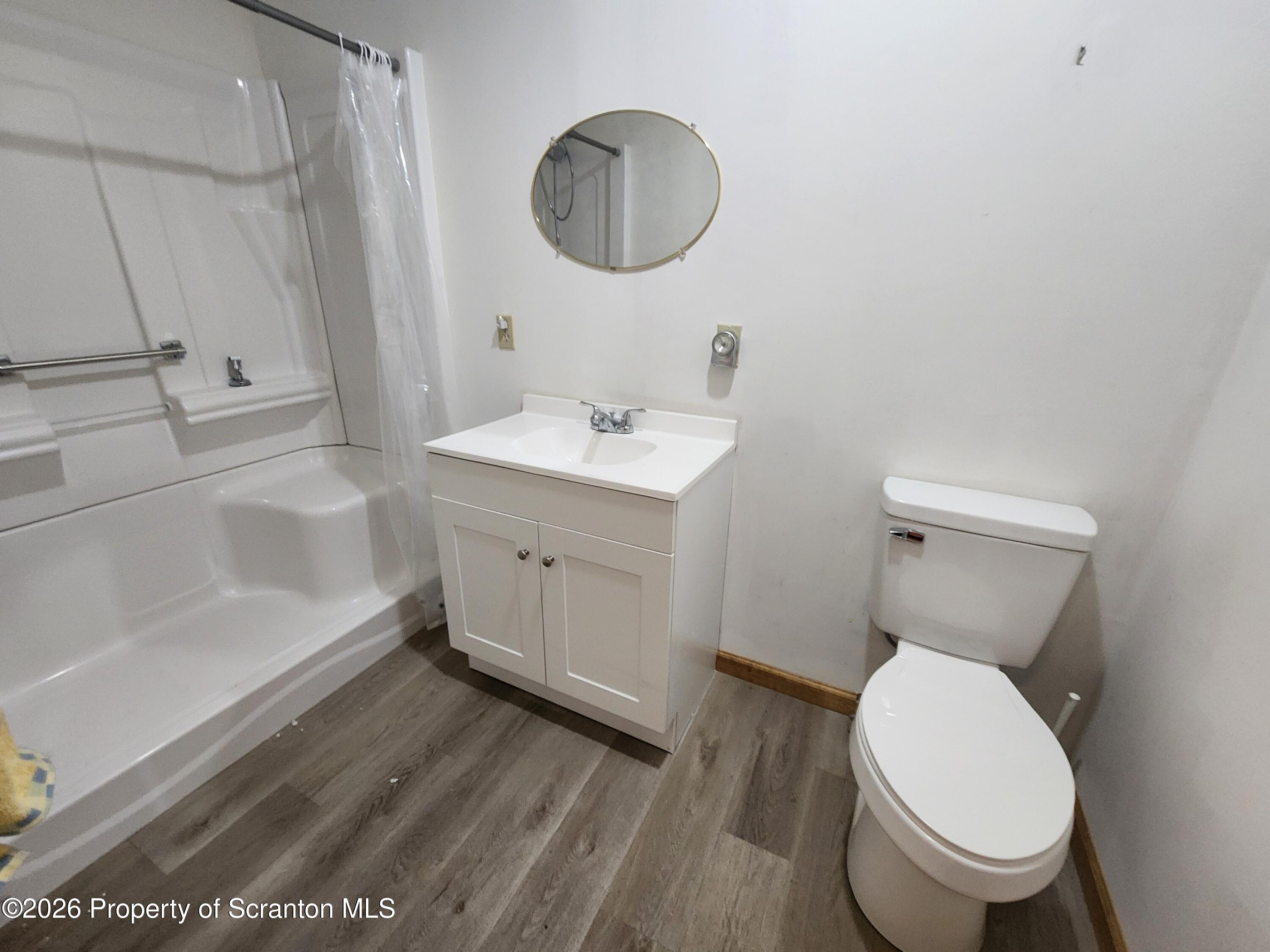648 Dundaff Street Carbondale, PA 18407 - Photo 23 of 35 a bathroom with a toilet a sink and bathtub