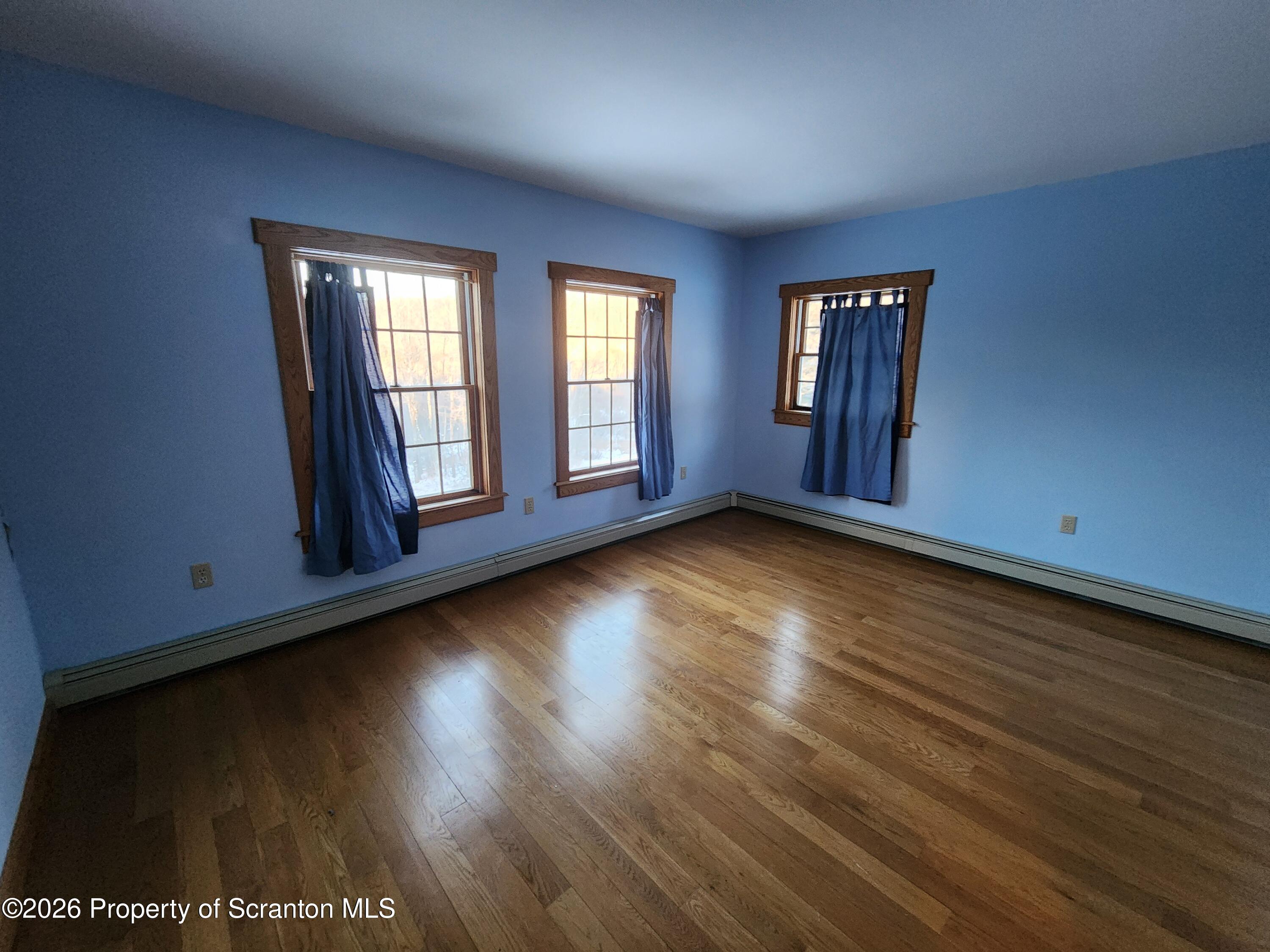 648 Dundaff Street Carbondale, PA 18407 - Photo 25 of 35 a view of an empty room with wooden floor and a window