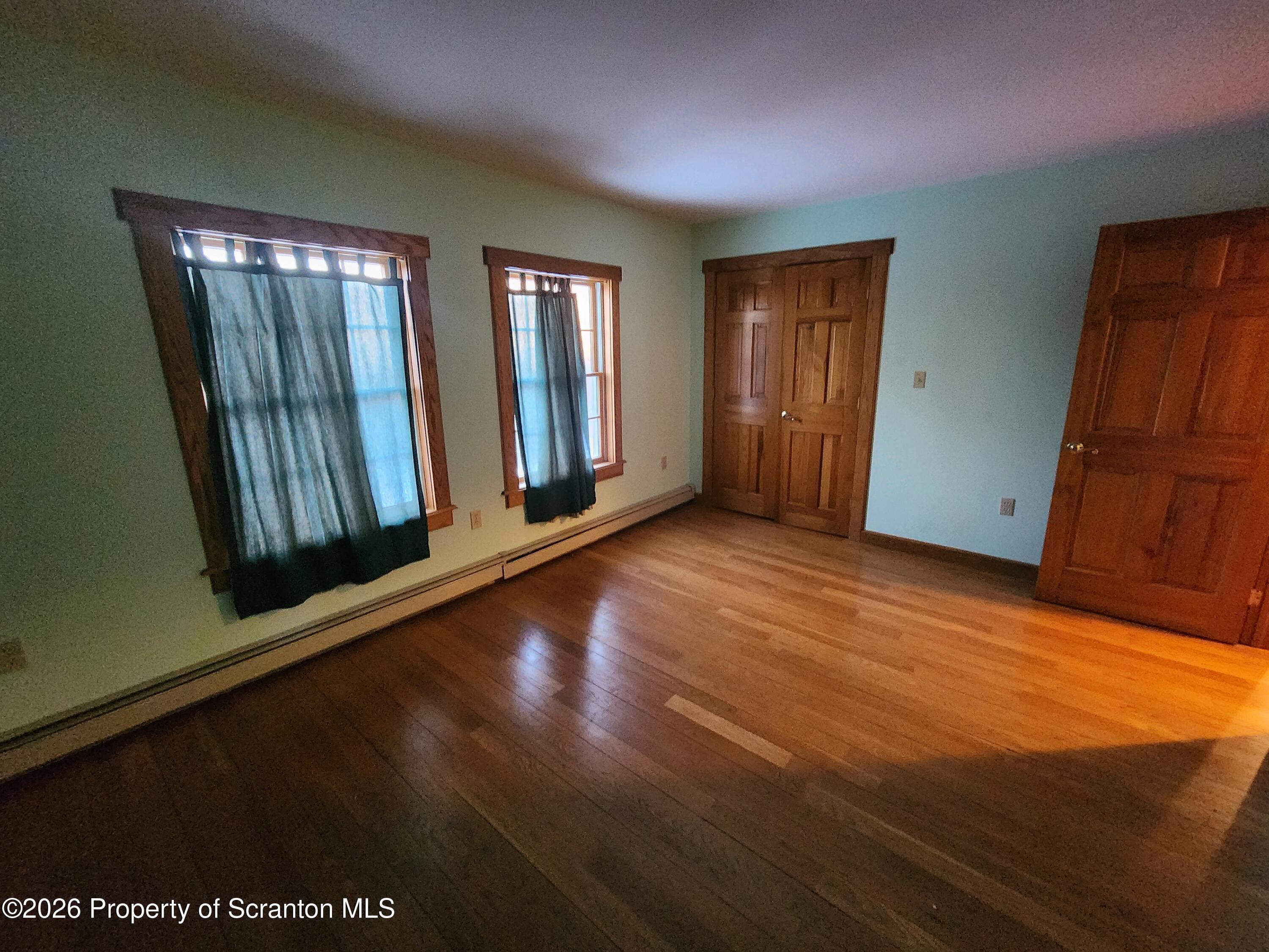 648 Dundaff Street Carbondale, PA 18407 - Photo 27 of 35 a view of an empty room with wooden floor and a window