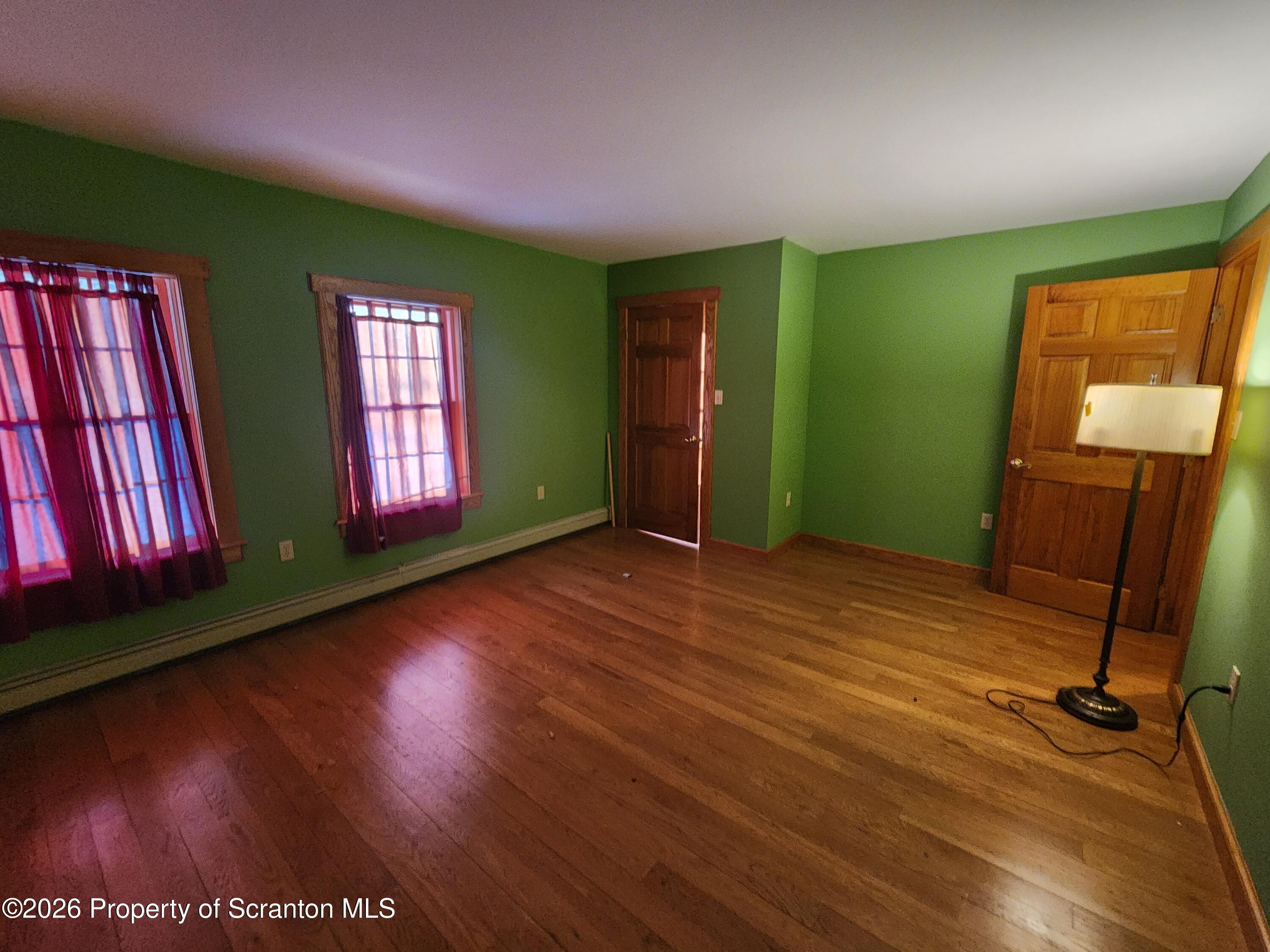 648 Dundaff Street Carbondale, PA 18407 - Photo 30 of 35 a view of an empty room with window and wooden floor