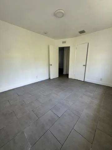 an empty room with a empty space and windows