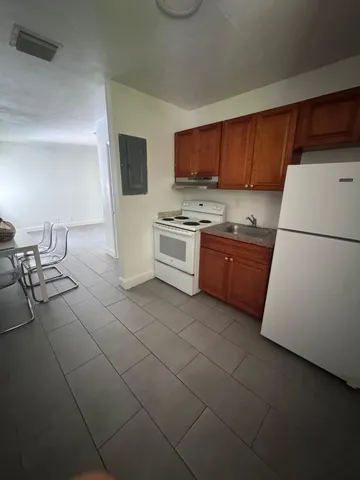 a kitchen with a sink and a refrigerator