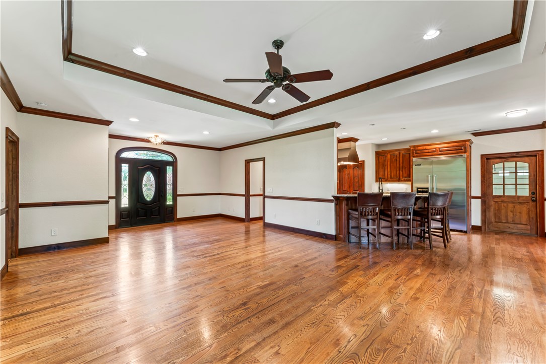 579 Terrapin Crossing Road Pickens, SC 29671 - Photo 6 of 50 Hardwood flooring extends throughout this generous living area, highlighted by a tray ceiling and a kitchen peninsula with seating.