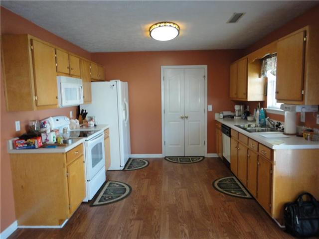 Convenient step saver kitchen with pantry and plenty of cabinet space. Stove, refrigerator, microwave, and dishwasher are included.