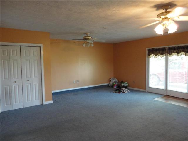 21x20 den with closet and doorway to the concrete driveway