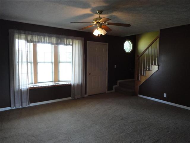 599 Parsons Road Christiana, TN 37037 - Photo 8 of 20 18x14 living room has a decorative bay window, ceiling fan, and stairway