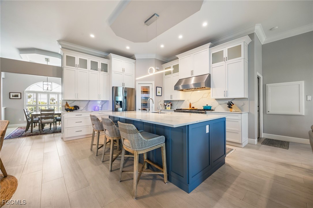 710 Birdie View Point Sanibel, FL 33957 - Photo 11 of 50 a kitchen with stainless steel appliances granite countertop a stove and a refrigerator