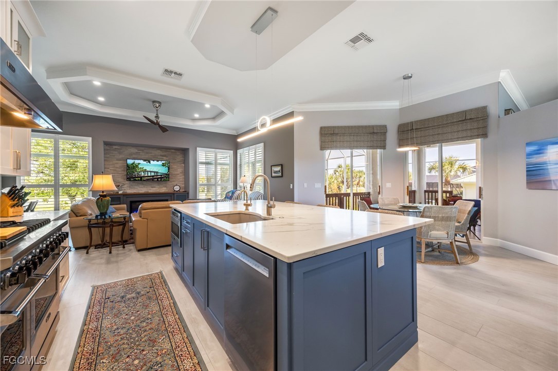710 Birdie View Point Sanibel, FL 33957 - Photo 13 of 50 a large kitchen with kitchen island a sink table and chairs
