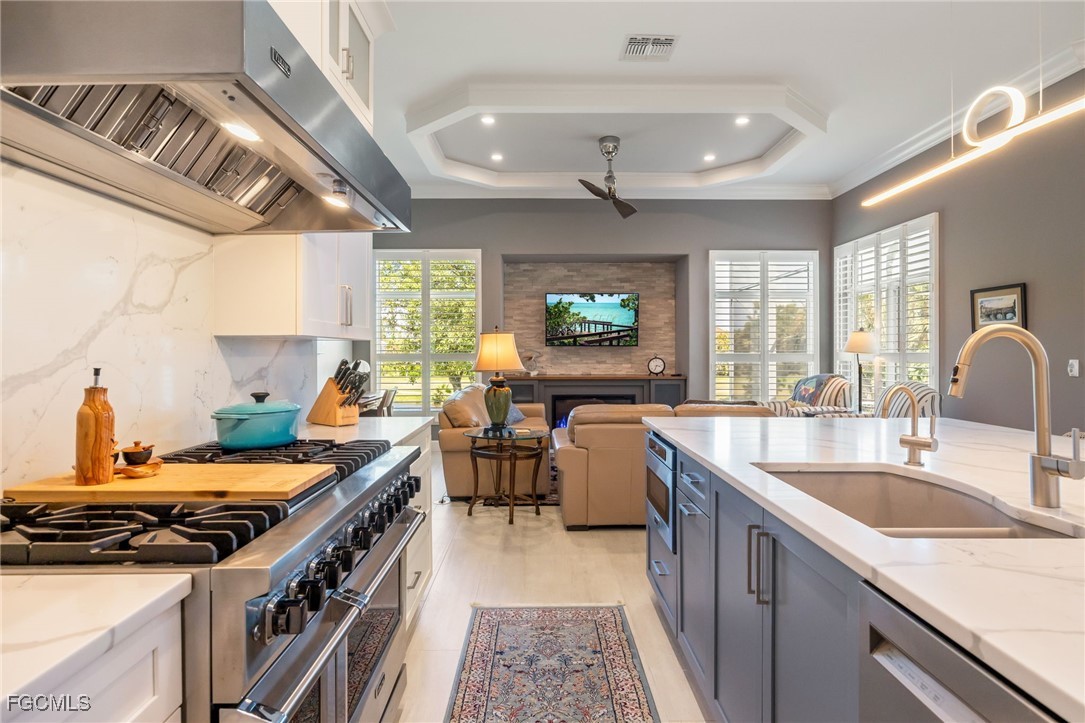 710 Birdie View Point Sanibel, FL 33957 - Photo 14 of 50 a kitchen with stainless steel appliances granite countertop a sink stove and cabinets