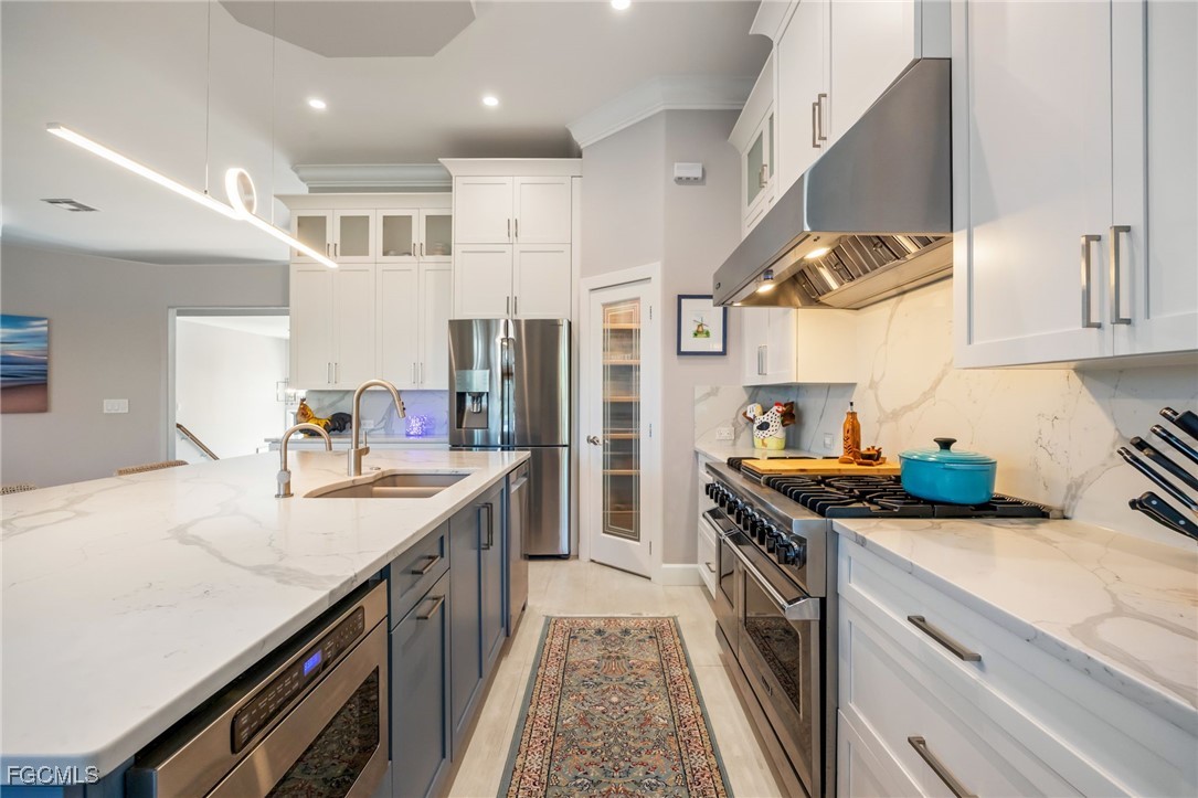 710 Birdie View Point Sanibel, FL 33957 - Photo 15 of 50 a kitchen with stainless steel appliances granite countertop a sink and a stove