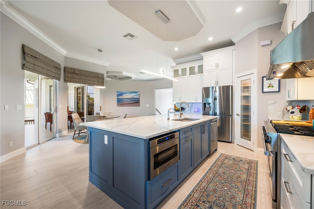 710 Birdie View Point Sanibel, FL 33957 - Photo 16 of 50 a kitchen with stainless steel appliances granite countertop a large stove a sink dishwasher and a refrigerator with wooden floor
