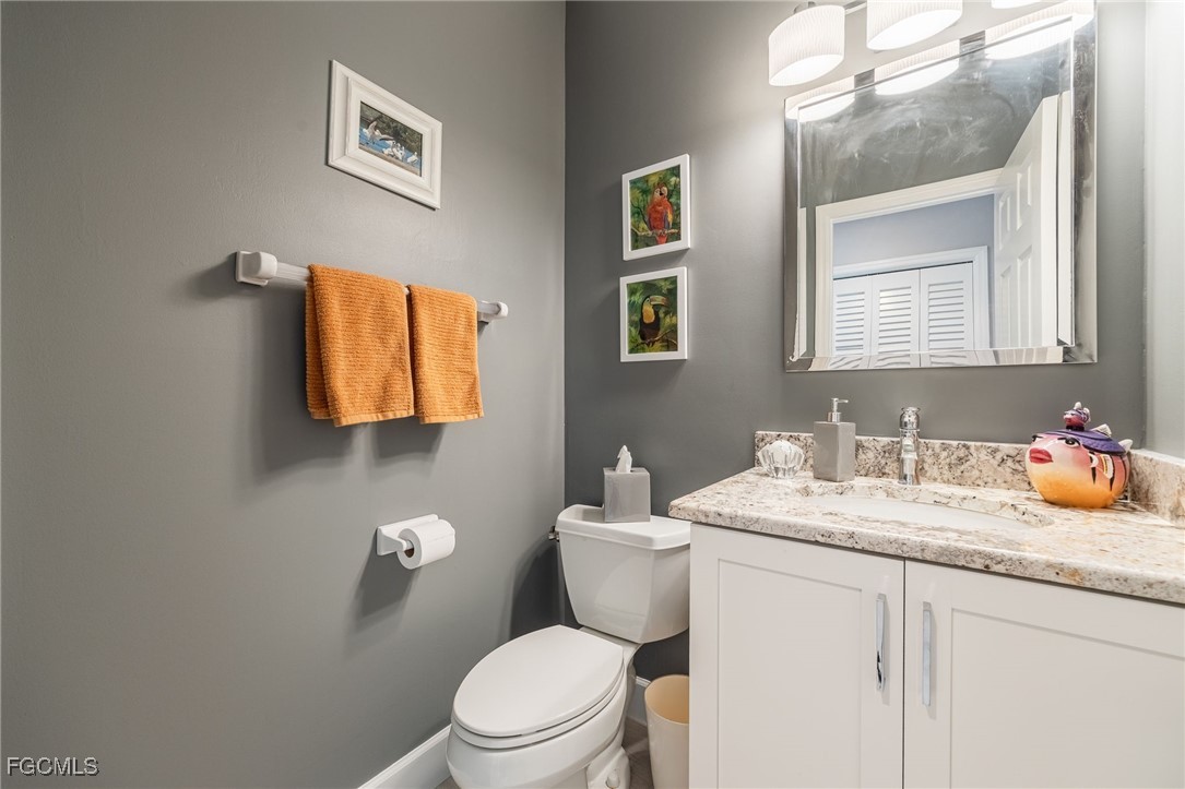 710 Birdie View Point Sanibel, FL 33957 - Photo 26 of 50 a bathroom with a toilet sink and mirror