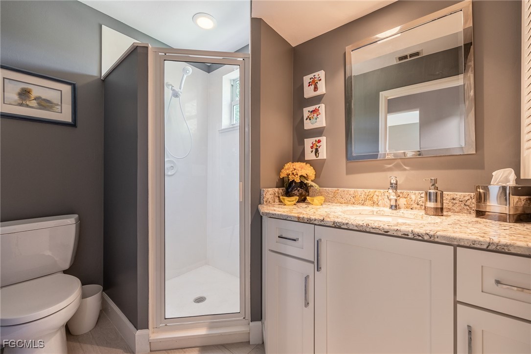 710 Birdie View Point Sanibel, FL 33957 - Photo 28 of 50 a bathroom with a granite countertop sink toilet and shower