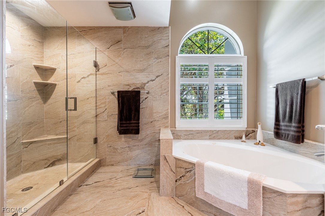710 Birdie View Point Sanibel, FL 33957 - Photo 31 of 50 a spacious bathroom with a bathtub and a shower