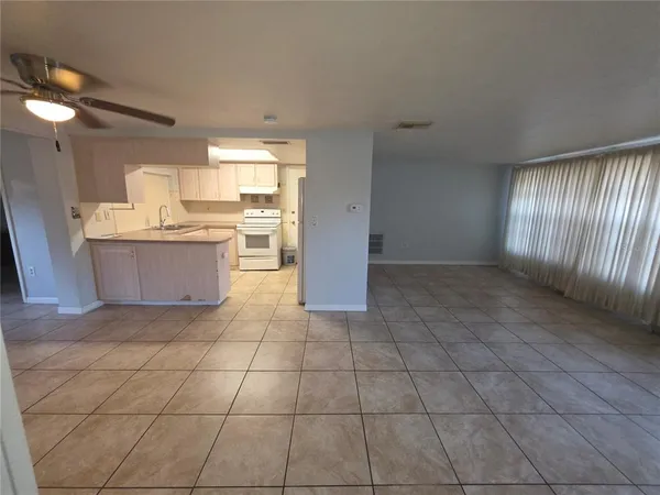 a view of a kitchen with dining area and windows