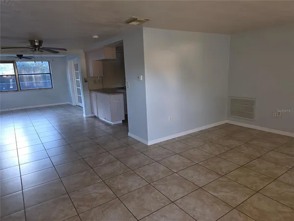 a view of a kitchen with an empty space and a window