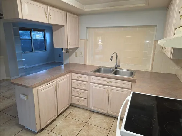 a kitchen with a sink and cabinets