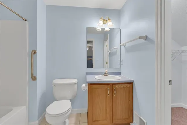 a bathroom with a toilet a sink and mirror