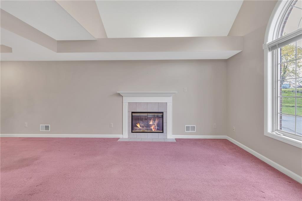 116 Windcrest Court Beaver Falls, PA 15010 - Photo 21 of 26 an empty room with a fireplace and windows