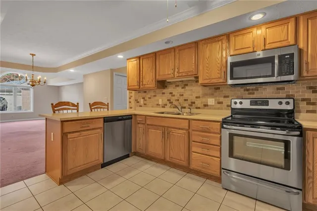 a kitchen with stainless steel appliances granite countertop a stove top oven microwave and cabinets