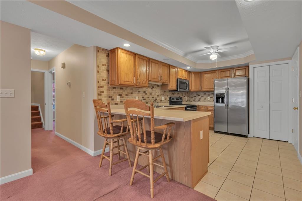 116 Windcrest Court Beaver Falls, PA 15010 - Photo 4 of 26 a kitchen with stainless steel appliances kitchen island granite countertop a refrigerator and cabinets