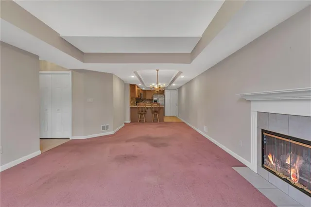 a furnished livingroom with a fireplace