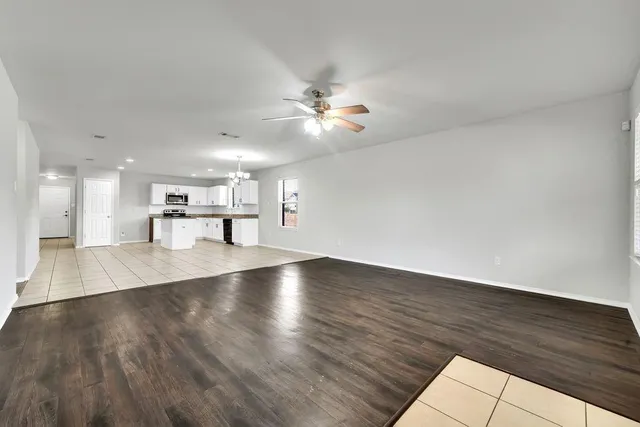 a view of kitchen and hall with wooden floor
