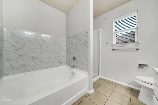 a bathroom with a bathtub and toilet