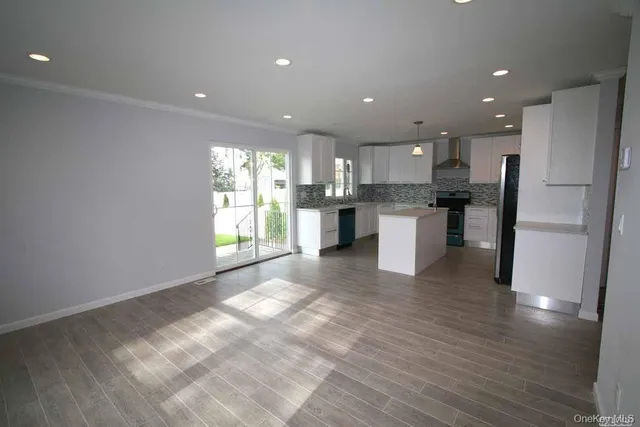 a view of a kitchen with a sink and microwave