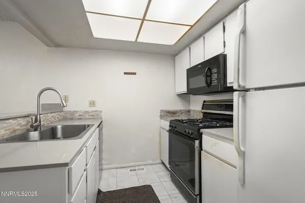a kitchen with a sink a stove and refrigerator