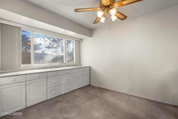 an empty room with a window and a fireplace